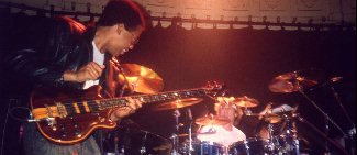 Stanley playing the bass with Stewart in the background